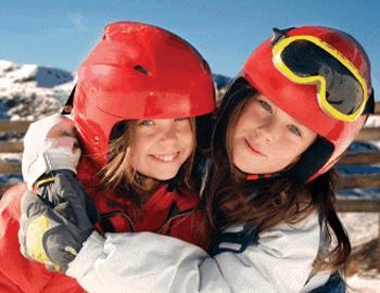 Kids wearing ski helmets and goggles