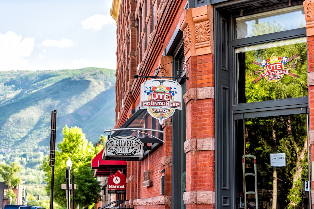 Town in Colorado with Ute Mountaineer store sign on vintage brick architecture on street sunny day