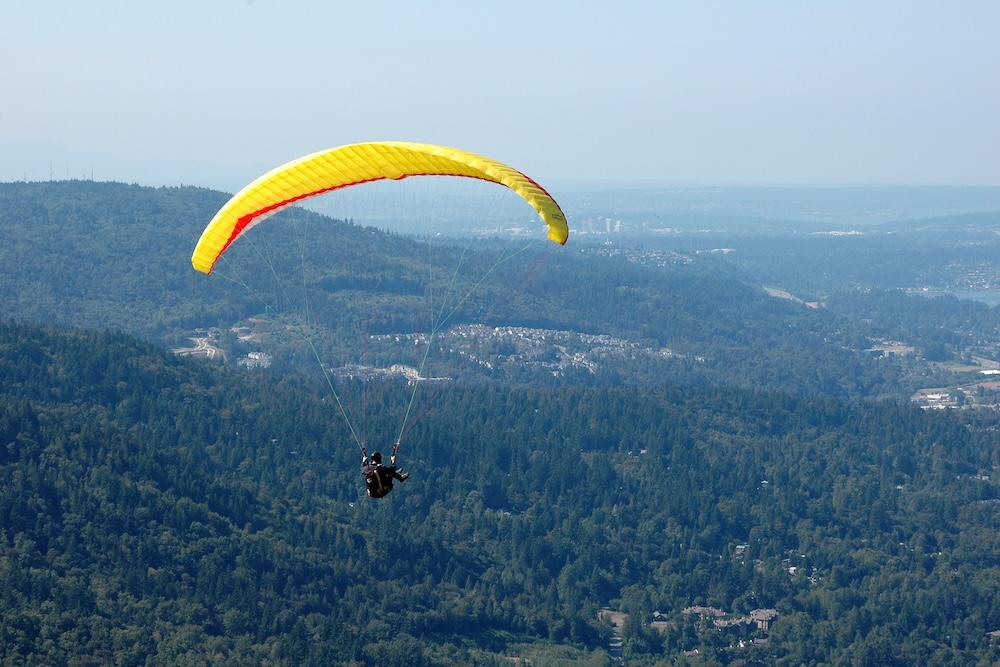 Paraglider flying over Denver Colorado suburbs
