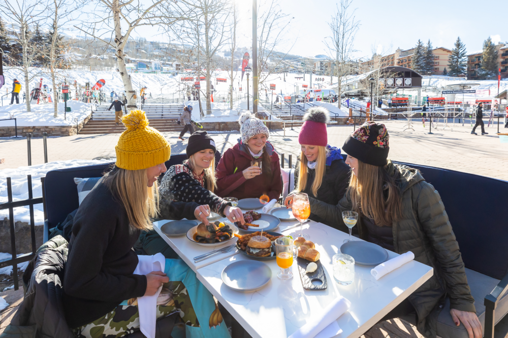 A group of woman celebrating the new year with lunch after skiing.
